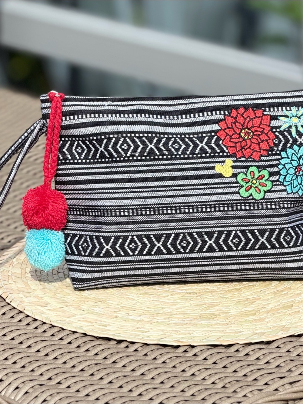 Black & White Embroidered Floral Zip Pouch with Red & Turquoise Pom Detail